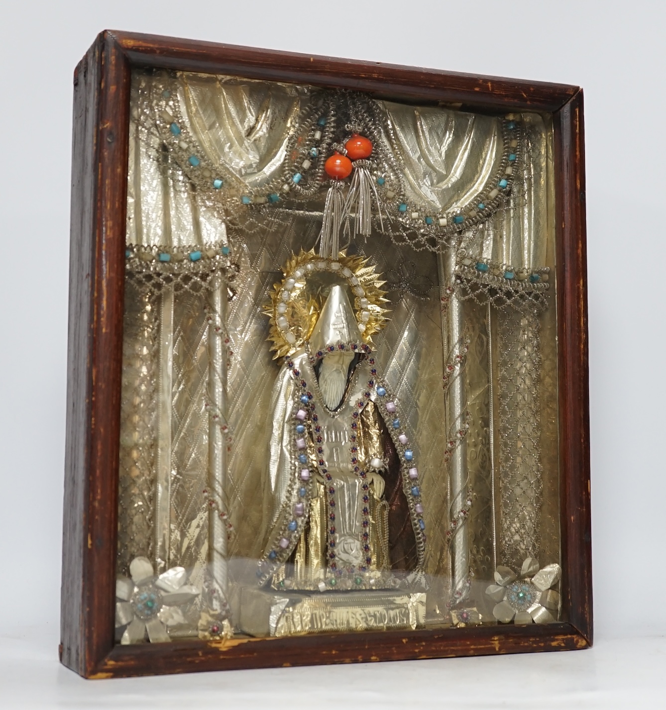 A Russian icon / figurative diorama, ‘Old Believers’, decorated with mixed metals and coloured beadwork, 33cm wide, 37cm high. Condition - case rubbed, good interior